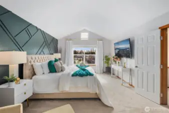 Oversized primary bedroom with french foors, vaulted ceilings and amazing natural light!