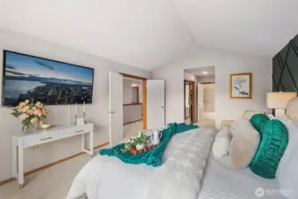 Dual walk in closets and primary bathroom in the distance