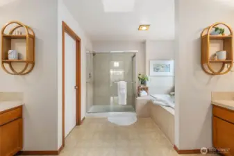 Separate vanities, large hower, soaking tub. Skylight offers more natural light