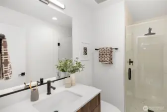 Third level bathroom.  Photo is of model home of same floorplan. Color schemes of finishes may vary.