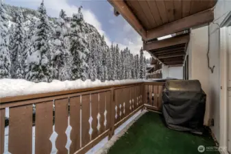 Private balcony overlooking the river with scenic mountain views beyond—an ideal spot to enjoy fresh alpine air, snowfall, and peaceful surroundings year-round.