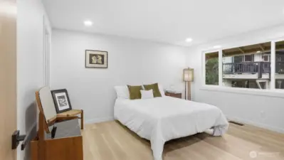 This spacious primary suite is flooded with natural light, thanks to an expansive window that showcases your golf course view!