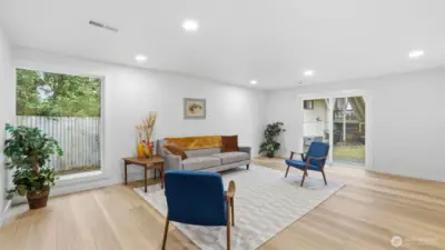 Spacious lower-level living area flows seamlessly outdoors via sliders, perfect for indoor-outdoor living.