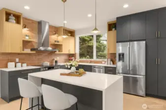 Cooking and dining come together with an island built for brunch spreads and homework sessions. Under cabinet lighting brightens every task.