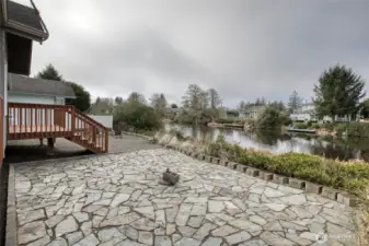 Large custom stone patio. Bring your outdoor dining table and enjoy the canal