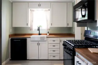 Stylish new vinyl plank flooring extends through the kitchen and dining area.