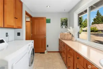 Large laundry/mudroom with a sink and ample storage