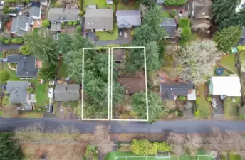 Aerial view of the home property showing the adjacent vacant lot.
