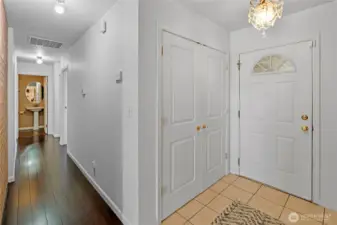 Main level hall leading to the bedrooms. The guest bath has since been painted white.