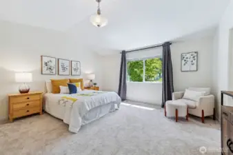 Primary bedroom is huge! Vaulted ceilings and space for sitting area. Looks out to backyard and open space.