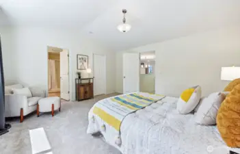Primary bedroom opens to en-suite bathroom and walk-in closet.