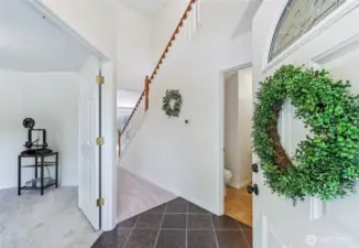 Step inside to the foyer with high, vaulted ceilings. Office space to the left is perfect for work at home days.