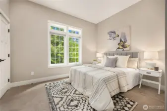 A spacious downstairs bedroom offers flexibility—ideal as a den, guest room, or home office.