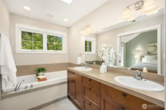 Enjoy a spa-like feel in the primary bath with double vanity, soaking tub, and separate shower.