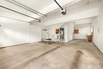 Tandem third bay currently functions as a workshop space with room for hobbies or projects.