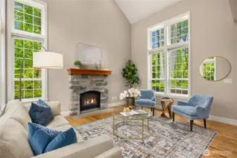 The light-filled living room centers around a cozy wood-burning fireplace—perfect for Northwest evenings.