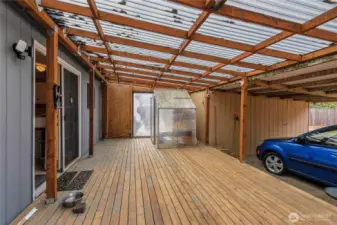 Large covered back deck with covered carport and tool shed