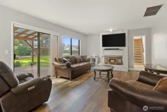 Living room flows into the back patio and backyard area.