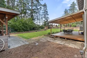 Detached covered area for grilling amazing meals is just a short walk from the back patio.