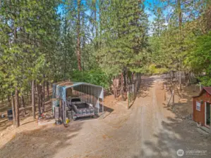 Carport and gated driveway into property