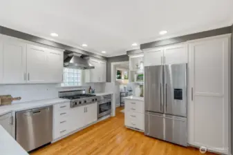 The kitchen has been fully remodeled with top of the line stainless appliances and quartz countertops.  A large deep sink, and lots of counter and cabinet space make this kitchen super functional as well as beautiful. Notice the large pantry cabinet to the right of the fridge, there is another set to the right of that as well!