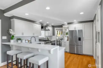 The kitchen is open to the family room, with a bar for casual dining and a perfect spot to chat with the cook.