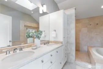The Primary bath features both a deep soaking tub and a large walk-in shower, as well as a double vanity with marble counters and tons of organized storage space.