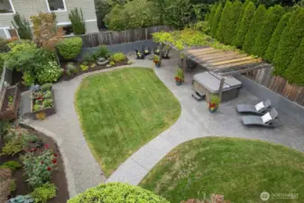 This yard was redone in 2020 to add the patio area and create multiple zones- garden beds for landscaping as well as vegetable and herb gardens, a spot for sun loungers, the hot tub, and a fire pit, as well as lots of level lawn for play space.