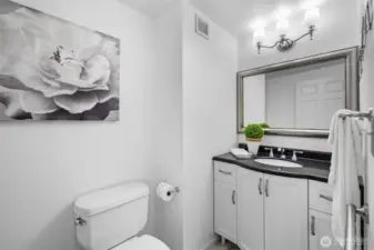 Half BaA stylish and convenient half bathroom located for easy access for guests, complete with a modern vanity and sink.th