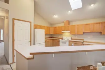 Kitchen has pantry storage and is flooded with natural light.