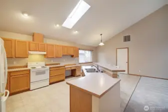 Roomy kitchen with large island and bar counter.