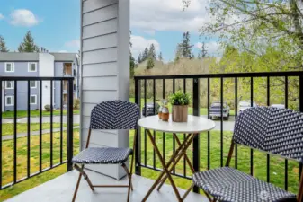 Private balcony opens onto lush greenspace.