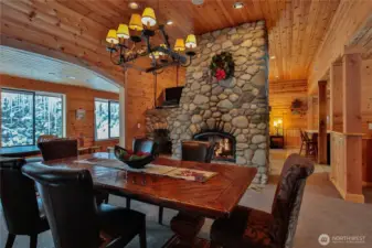 Spacious dining area with rustic wood finishes, statement chandelier, and seamless connection to the living spaces.