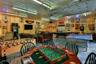 Expansive game room featuring pool table, foosball, ping pong, and multiple entertainment areas—designed for gathering and recreation.