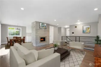 Open Concept Main Floor Living/Dining Area w/ Hardwood Floors & Fireplace Virtually Staged