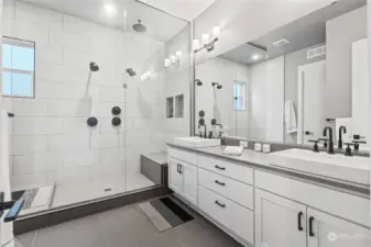 Stunning primary suite bath! Talk about luxury with dual shower heads, full glass surround, rainhead shower and more custom tile work!