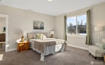 The large primary bedroom featuring a walk-in closet and en-suite.