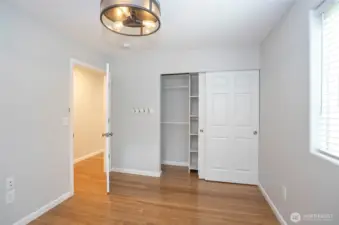 The primary suite offers ample closet space with built-in shelving for optimal organization.