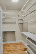 Keep organized with a custom walk-in closet offering shelving, hanging space & drawers.