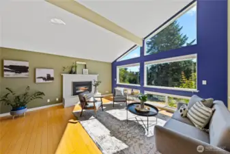 Light and bright living room with a wall of windows overlooking the yard.