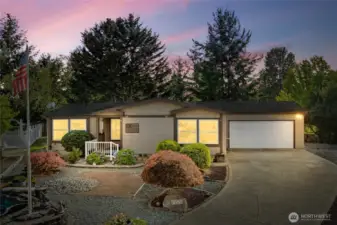 Welcome Home! Low Maintenance front yard with ample parking and double garage. (Sky has been photo enhanced)