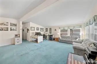 Open expansive living room with ample room for a corner office for easy work at home access.
