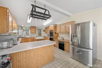 Looking into your massive kitchen with counter space and storage galore.