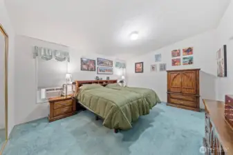 Primary bedroom suite with attached five piece bathroom and enormous walk in closet.