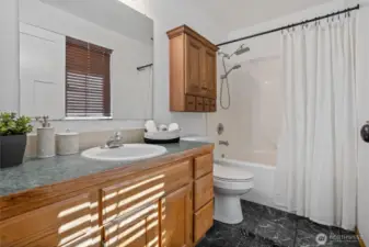 Primary bathroom with tub & shower combo.