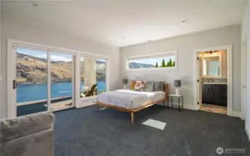 Downstairs is also full of light! Here is the second en suite bedroom. Very spacious, walk in closet, deck access and beautiful views!
