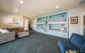 Custom built in bunk beds with storage stairs and drawers underneath! This was the happy home for "cousin camp" for many years. Wall mounted TV to the right just out of view.