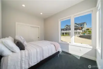 Upstairs there is another bedroom across from the primary with a bright sunny neighborhood view. This guest room is ideal for people wishing to avoid the stairs, bathroom is right next door, too.
