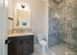 Gorgeous 3/4 bath next to the guest room on the main level. This level entry shower with no lip and inline drain makes this space so accessible. That brings the total to 4 bedrooms, four bathrooms (2 of them en suite) plus the bunkroom! Lots of space to enjoy!