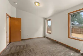 Spacious primary suite with vaulted ceiling, walk-in closet and 3/4 bath.